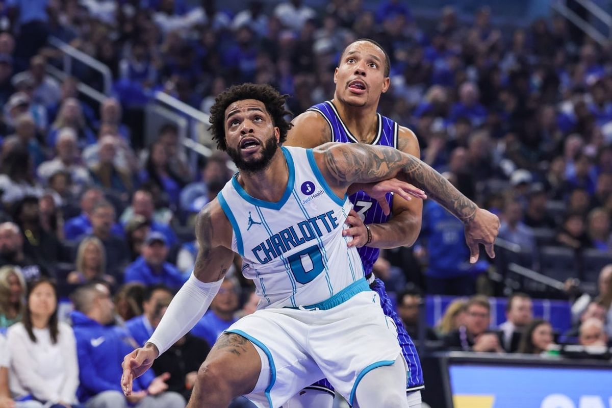 Apr 17, 2026; Orlando, Florida, USA; Charlotte Hornets forward Miles Bridges (0) and Orlando Magic guard Desmond Bane (3) look for the rebound during the second quarter during the play-in rounds of the 2026 NBA Playoffs at Kia Center. Mandatory Credit: Mike Watters-Imagn Images