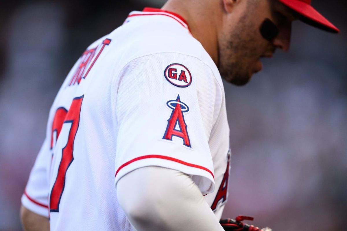 Apr 17, 2026; Anaheim, California, USA; A patch honoring former Los Angeles Angels player Garret Anderson is seen on the sleeve of center fielder Mike Trout (27) during the first inning against the San Diego Padres at Angel Stadium. Mandatory Credit: William Liang-Imagn Images