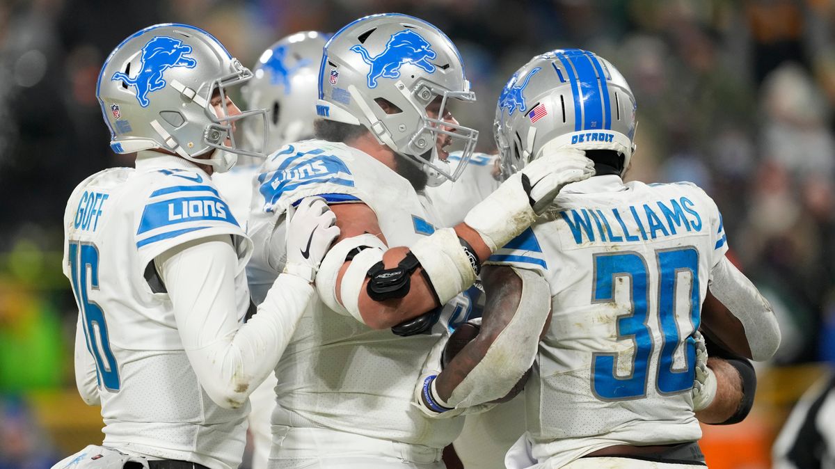 Jamaal Williams celebrates with teammates after scoring a touchdown during the fourth quarter against the Green Bay Packers at Lambeau Field on Jan.   8, 2023,  in Green Bay, Wisconsin.