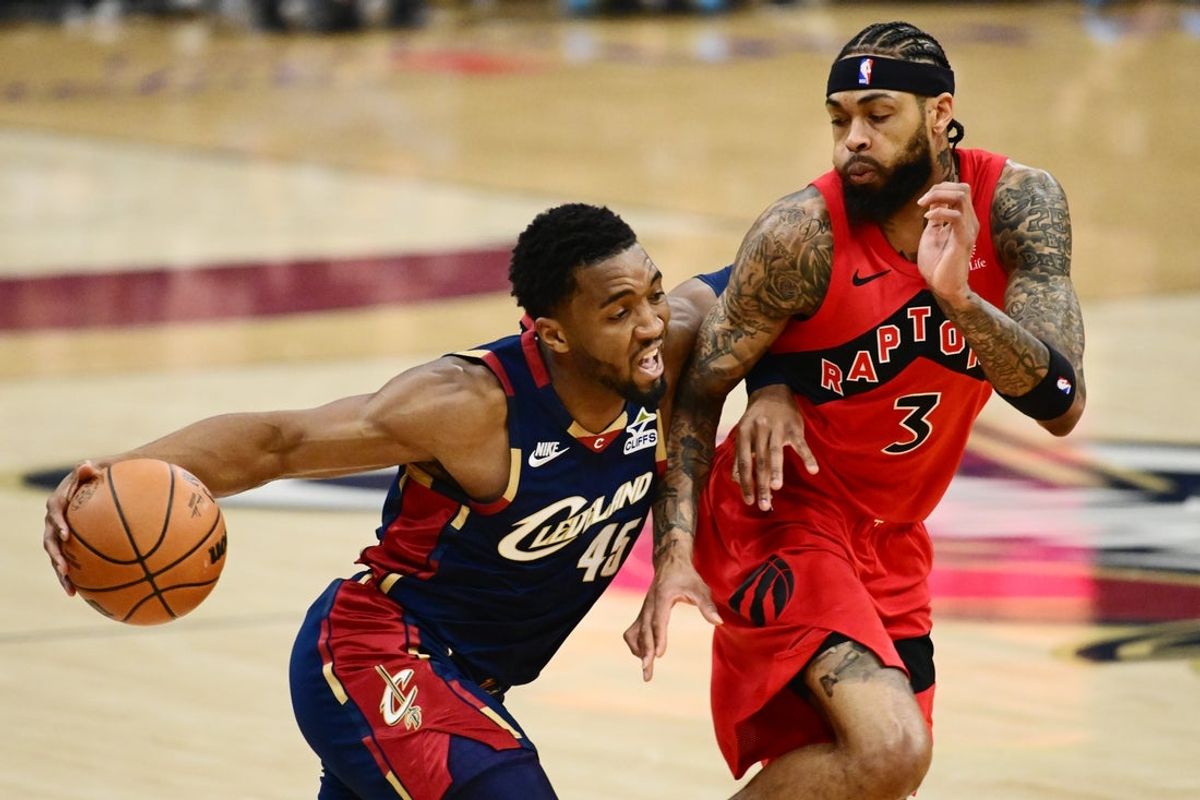 Apr 18, 2026; Cleveland, Ohio, USA; Cleveland Cavaliers guard Donovan Mitchell (45) drives to the basket against Toronto Raptors forward Brandon Ingram (3) during the first quarter of game one in the first round of the 2026 NBA Playoffs at Rocket Arena. Mandatory Credit: Ken Blaze-Imagn Images