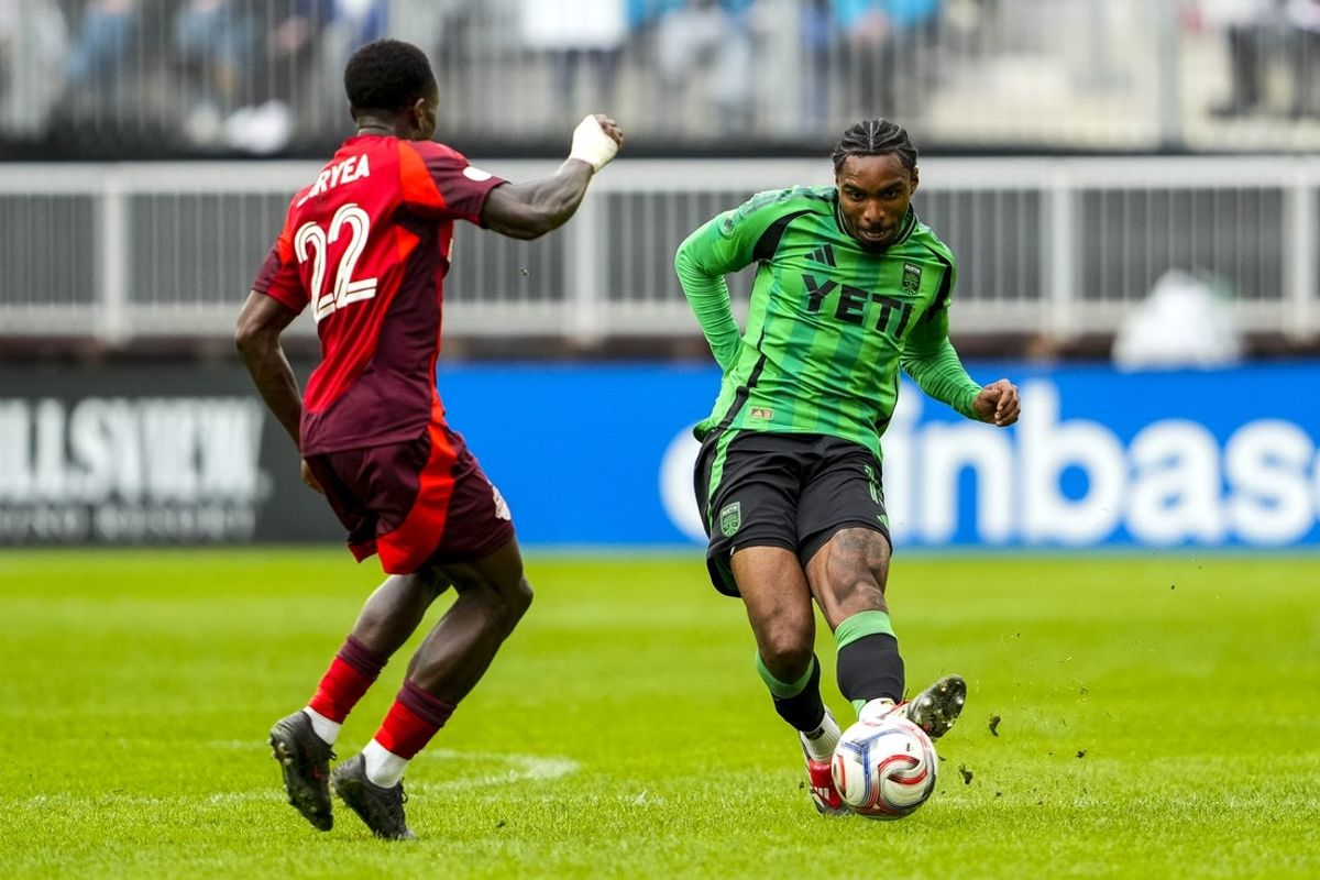 Apr 18, 2026; Toronto, Ontario, CAN; Austin FC defender Jon Bell (15) passes the ball against Toronto FC defender Richie Laryea (22) during the first half at BMO Field. Mandatory Credit: Kevin Sousa-Imagn Images