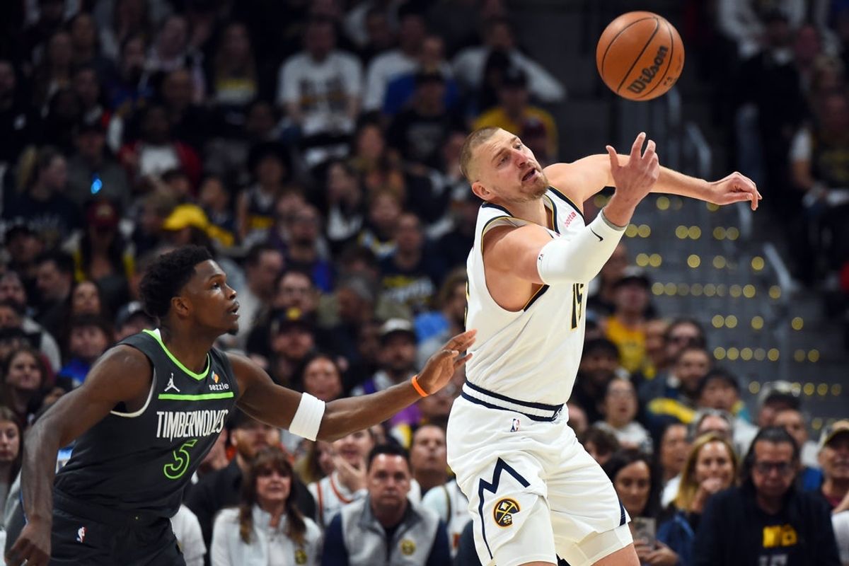 Apr 18, 2026; Denver, Colorado, USA; Denver Nuggets center Nikola Jokic (15) is fouled by Minnesota Timberwolves guard Anthony Edwards (5) as he handles the ball during the first half in game one of the first round of the 2026 NBA Playoffs at Ball Arena. Mandatory Credit: Christopher Hanewinckel-Imagn Images