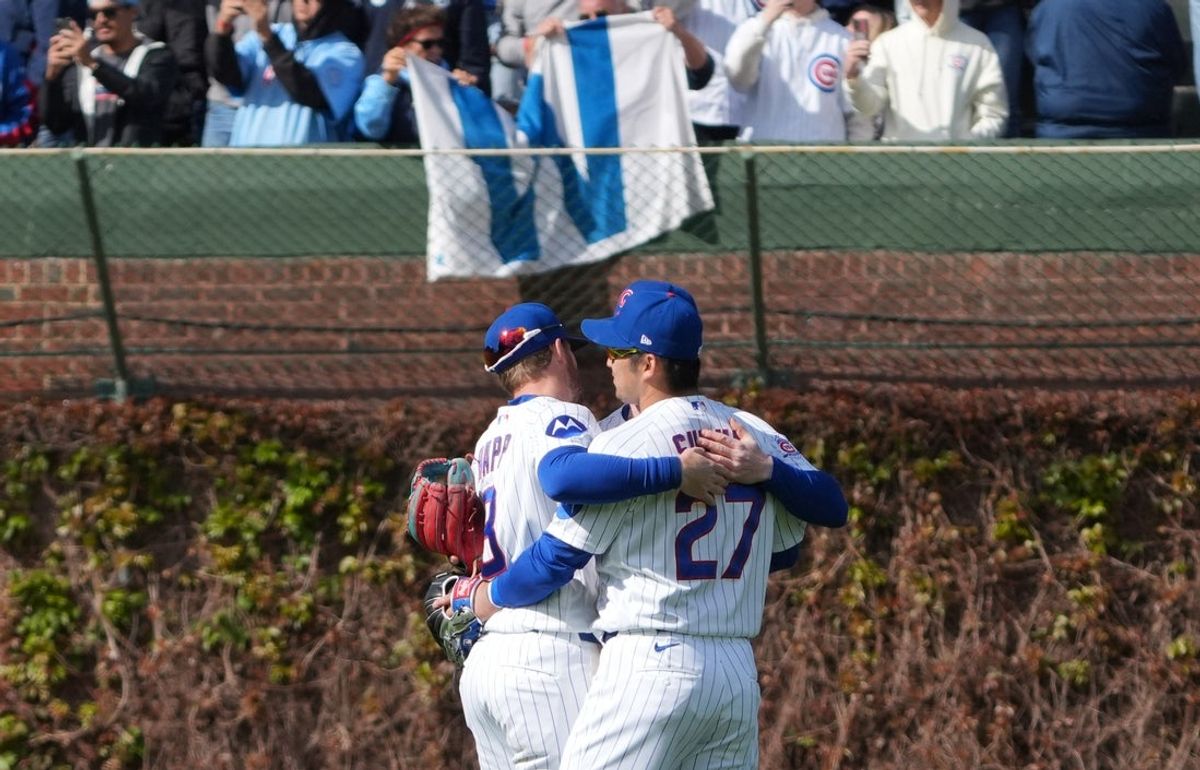 Apr 18, 2026; Chicago, Illinois, USA; Chicago Cubs right fielder Seiya Suzuki (27) and left fielder Ian Happ (8) celebrate their win against the New York Mets at Wrigley Field. Mandatory Credit: David Banks-Imagn Images