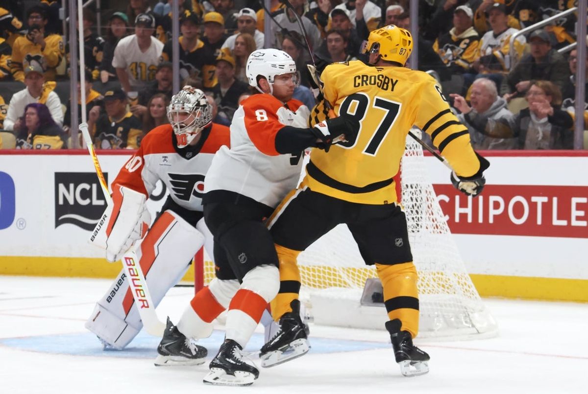 Apr 18, 2026; Pittsburgh, Pennsylvania, USA; Philadelphia Flyers defenseman Cam York (8) checks Pittsburgh Penguins center Sidney Crosby (87) in front of Flyers goaltender Dan Vladar (80) during the first period against in game one of the first round of the 2026 Stanley Cup Playoffs at PPG Paints Arena. Mandatory Credit: Charles LeClaire-Imagn Images