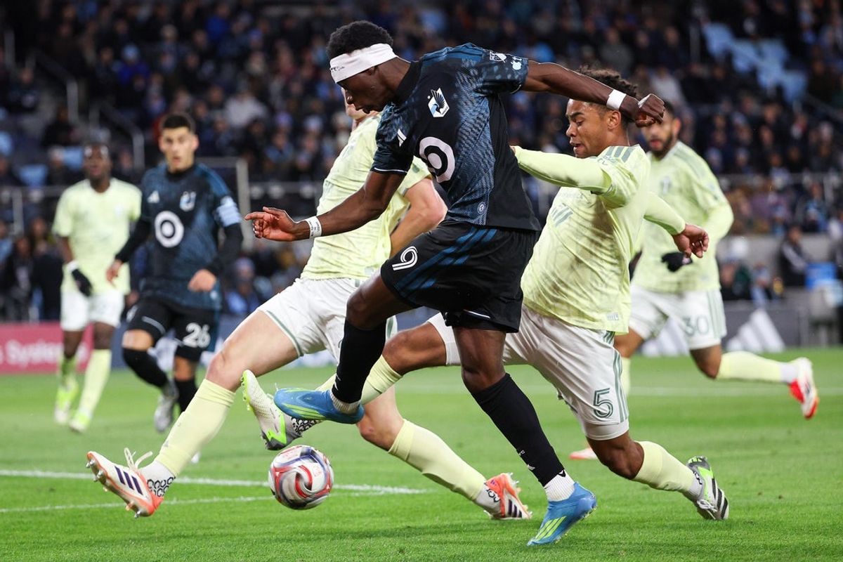 Apr 18, 2026; Saint Paul, Minnesota, USA; Minnesota United FC forward Kelvin Yeboah (9) shoots the ball as Portland Timbers defender Finn Surman (20) and defender Brandon Bye (5) defend during the first half at Allianz Field. Mandatory Credit: Matt Krohn-Imagn Images
