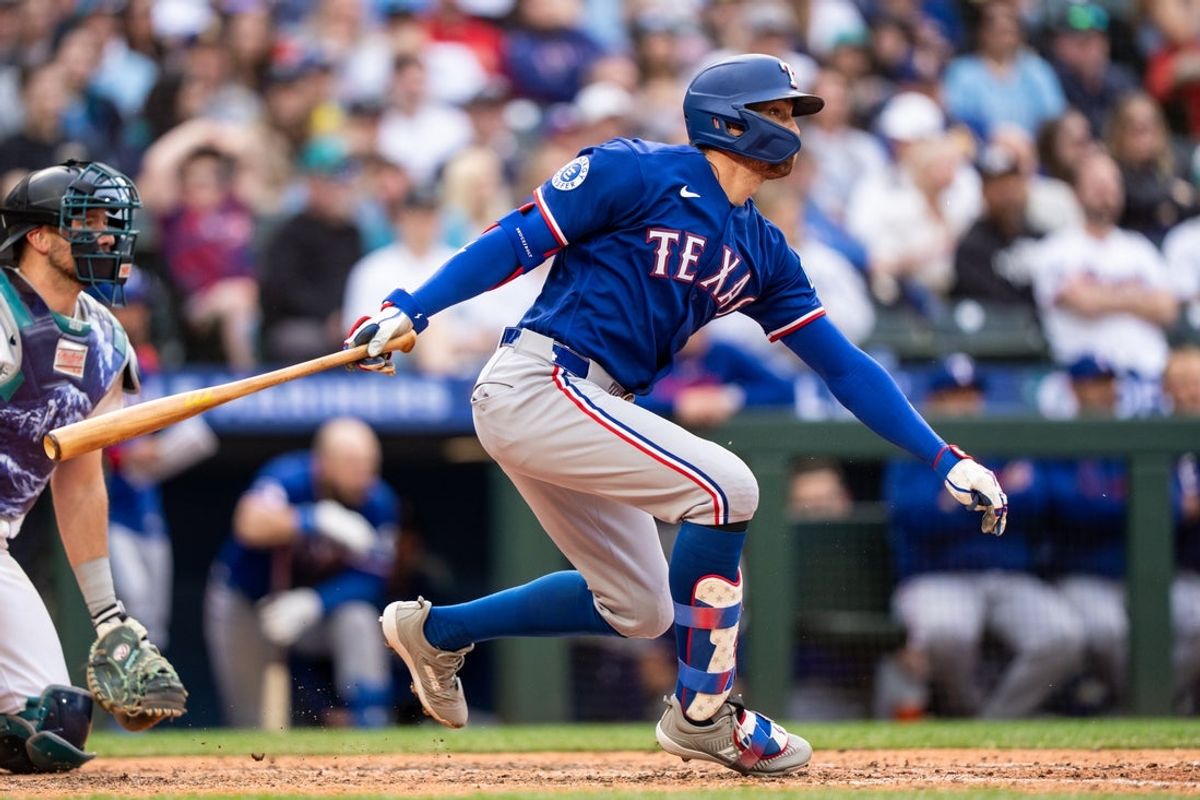 Apr 18, 2026; Seattle, Washington, USA; Texas Rangers right fielder Brandon Nimmo (24) hits a single during the eighth inning against the Seattle Mariners at T-Mobile Park. The hit was the 1,000th hit of his career. Mandatory Credit: Stephen Brashear-Imagn Images