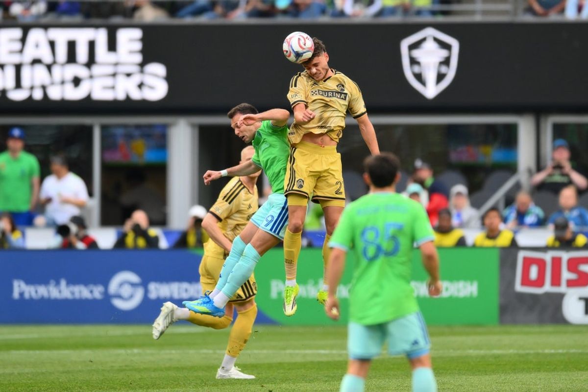 Apr 18, 2026; Seattle, Washington, USA; St. Louis City midfielder Dante Polvara (21) heads the ball over Seattle Sounders FC forward Daniel Musovski (19) during the first half at Lumen Field. Mandatory Credit: Steven Bisig-Imagn Images