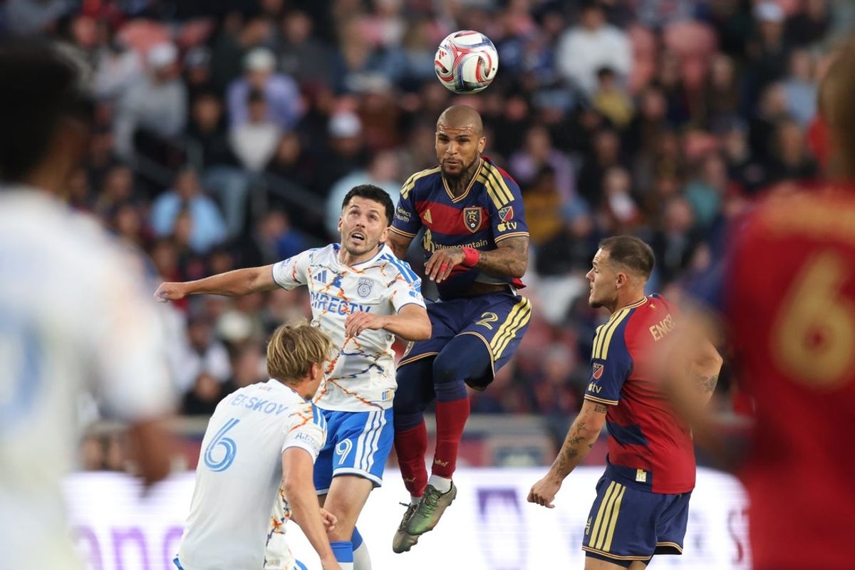 Apr 18, 2026; Sandy, Utah, USA; San Diego FC forward Lewis Morgan (9) and Real Salt Lake defender DeAndre Yedlin (2) play for a head ball during the first half at America First Field. Mandatory Credit: Rob Gray-Imagn Images