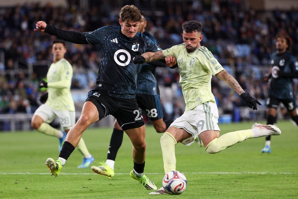 Apr 18, 2026; Saint Paul, Minnesota, USA; Portland Timbers forward Kristoffer Velde (99) controls the ball as Minnesota United FC defender Morris Duggan (23) defends  during the second half at Allianz Field. Mandatory Credit: Matt Krohn-Imagn Images