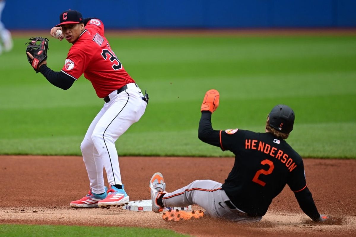 Apr 19, 2026; Cleveland, Ohio, USA; Cleveland Guardians second baseman Juan Brrito (34) throws to first base for a double play after firing out Baltimore Orioles shortstop Gunnar Henderson (2) at second base during the first inning at Progressive Field. Mandatory Credit: David Dermer-Imagn Images