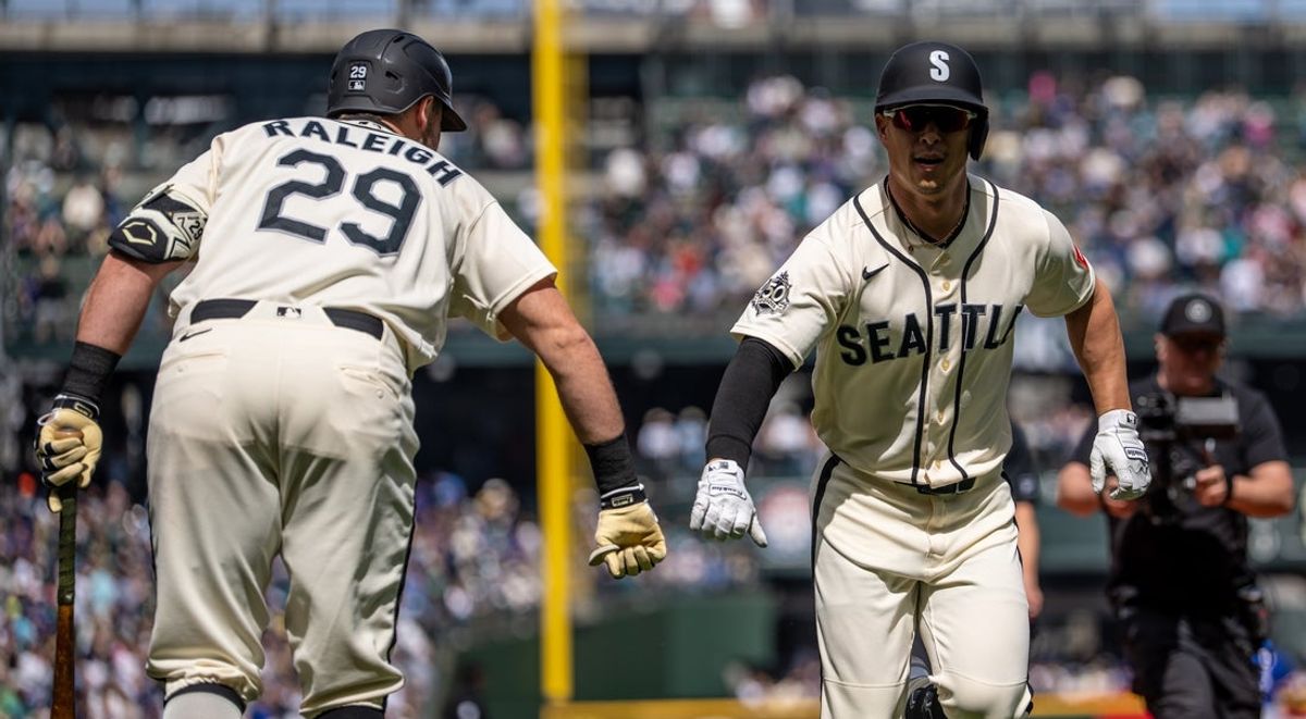 Apr 19, 2026; Seattle, Washington, USA; Seattle Mariners right fielder Rob Refsnyder (30) is congratulated by designated hitter Cal Raleigh (29) after hitting a solo home run during the first inning against the Texas Rangers at T-Mobile Park. Mandatory Credit: Stephen Brashear-Imagn Images