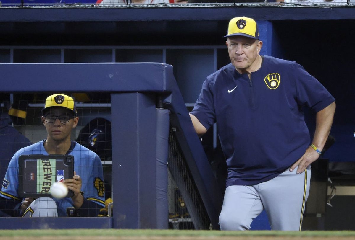 Apr 19, 2026; Miami, Florida, USA;  Milwaukee Brewers manager Pat Murphy (49) watches from the dugout steps against the Miami Marlins during the first inning at loanDepot Park. Mandatory Credit: Rhona Wise-Imagn Images