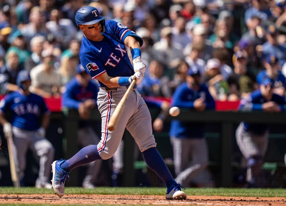 Apr 19, 2026; Seattle, Washington, USA; Texas Rangers third baseman Josh Jung (6) hits a RBI-sacrifice fly during the seventh inning against the Seattle Mariners at T-Mobile Park. Mandatory Credit: Stephen Brashear-Imagn Images