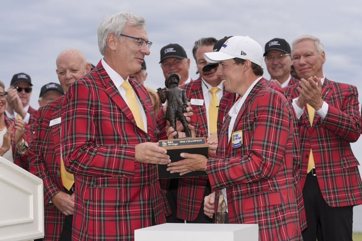 Apr 19, 2026; Hilton Head, South Carolina, USA; Matt Fitzpatrick celebrates his playoff win and receives his plaid jacket and his trophy after the overtime win of the RBC Heritage golf tournament. Mandatory Credit: Jim Dedmon-Imagn Images