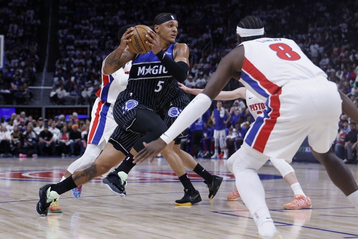 Apr 19, 2026; Detroit, Michigan, USA; Orlando Magic forward Paolo Banchero (5) dribbles defended by Detroit Pistons guard Caris LeVert (8) in the second half during the 2026 NBA Playoffs at Little Caesars Arena. Mandatory Credit: Rick Osentoski-Imagn Images