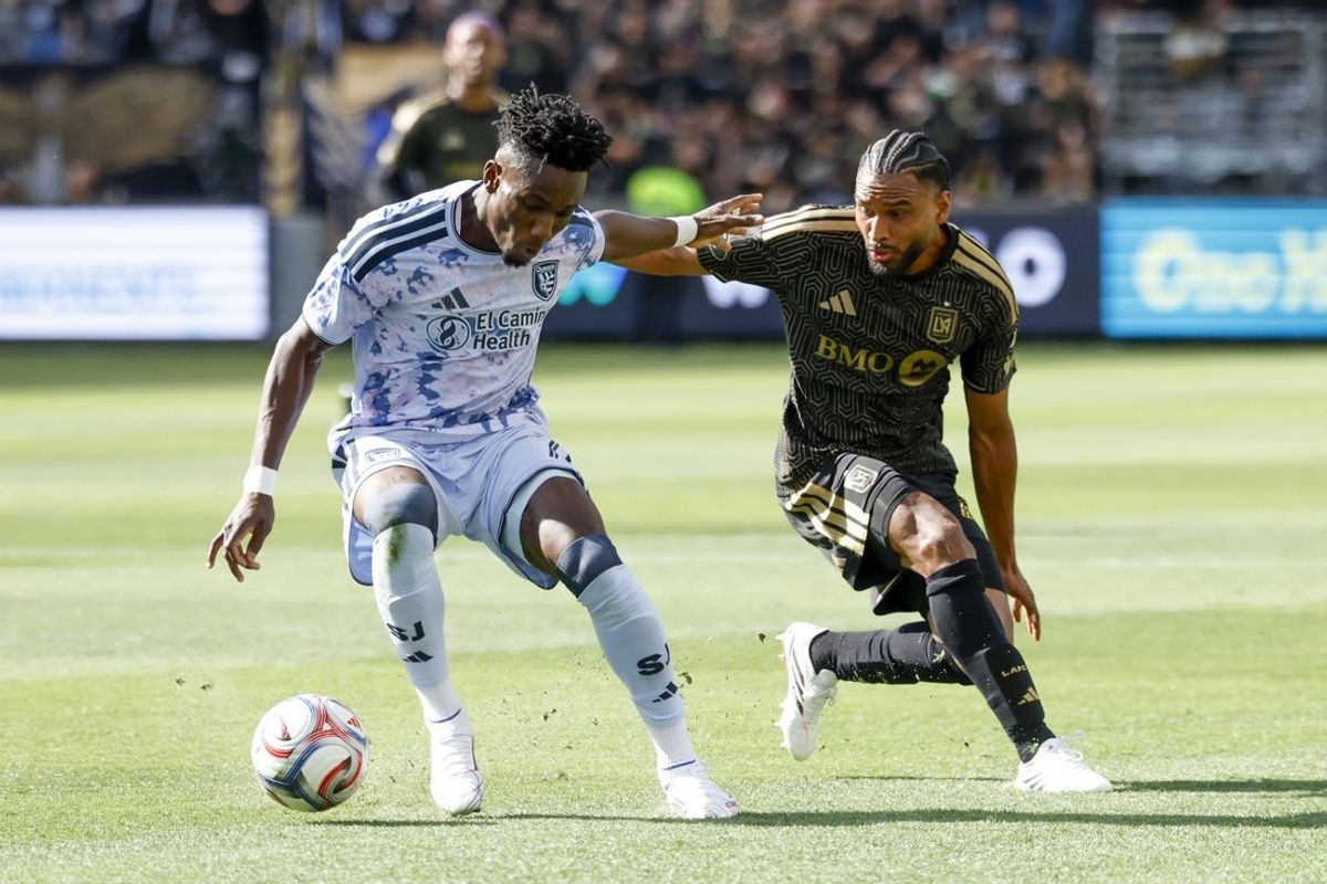 Apr 19, 2026; Los Angeles, California, USA; San Jose Earthquakes forward Ousseni Bouda (7) runs with the ball against Los Angeles Football Club defender Eddie Segura (4) during the first period at BMO Stadium. Mandatory Credit: William Navarro-Imagn Images