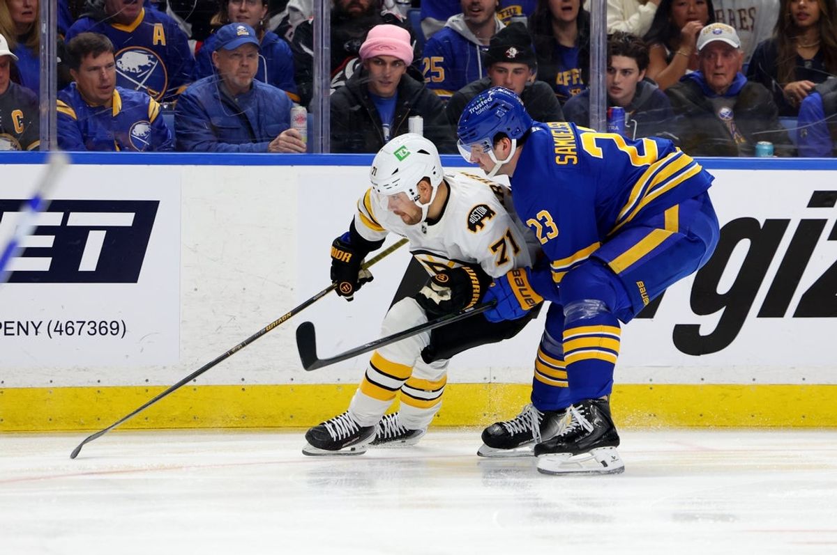Apr 19, 2026; Buffalo, New York, USA; Boston Bruins left wing Viktor Arvidsson (71) and Buffalo Sabres defenseman Mattias Samuelsson (23) go after a loose puck during the first period in game one of the first round of the 2026 Stanley Cup Playoffs at KeyBank Center. Mandatory Credit: Timothy T. Ludwig-Imagn Images