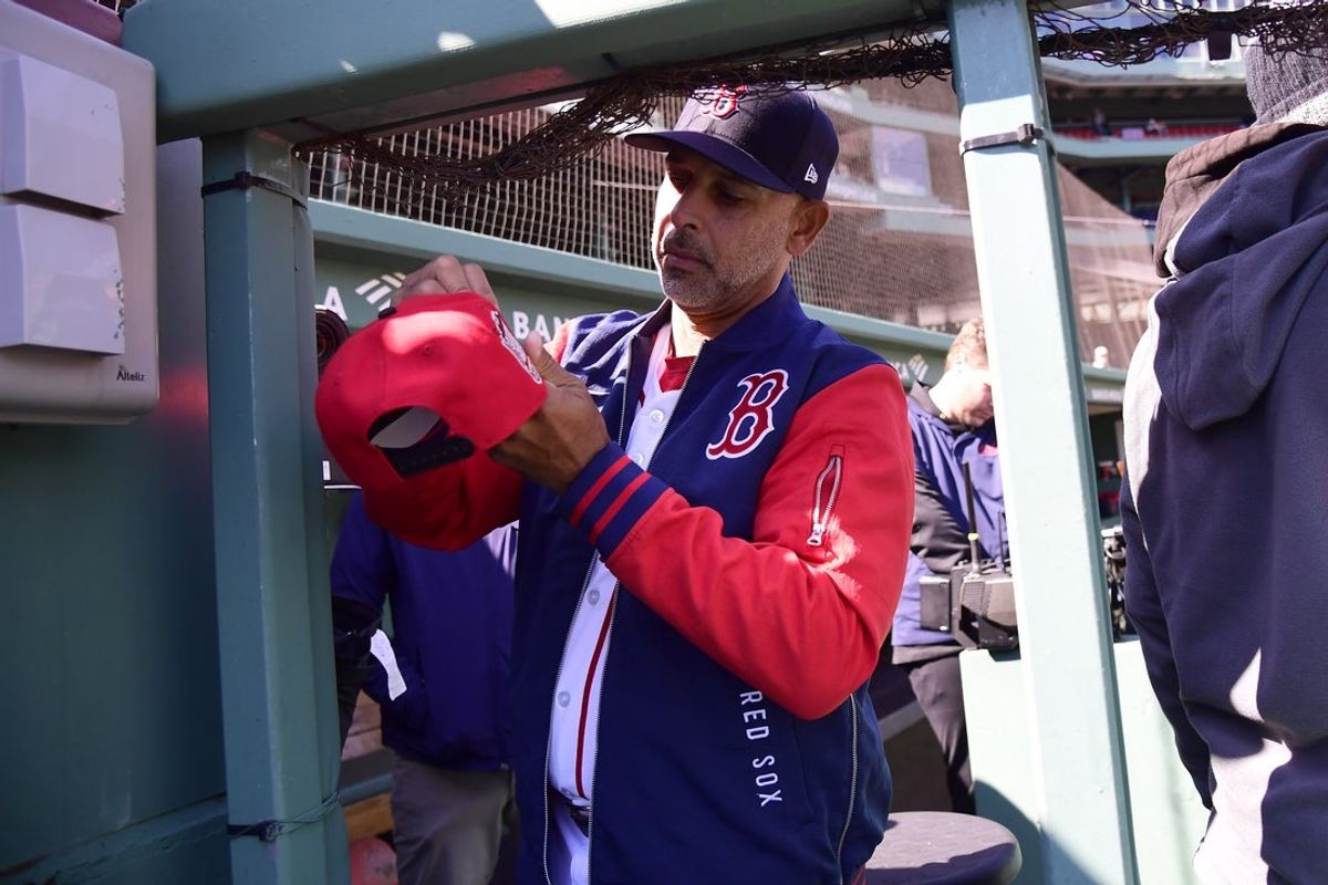 Apr 20, 2026; Boston, Massachusetts, USA;  Boston Red Sox manager Alex Cora signs a hat for a fan prior to a game against the Detroit Tigers at Fenway Park. Mandatory Credit: Bob DeChiara-Imagn Images