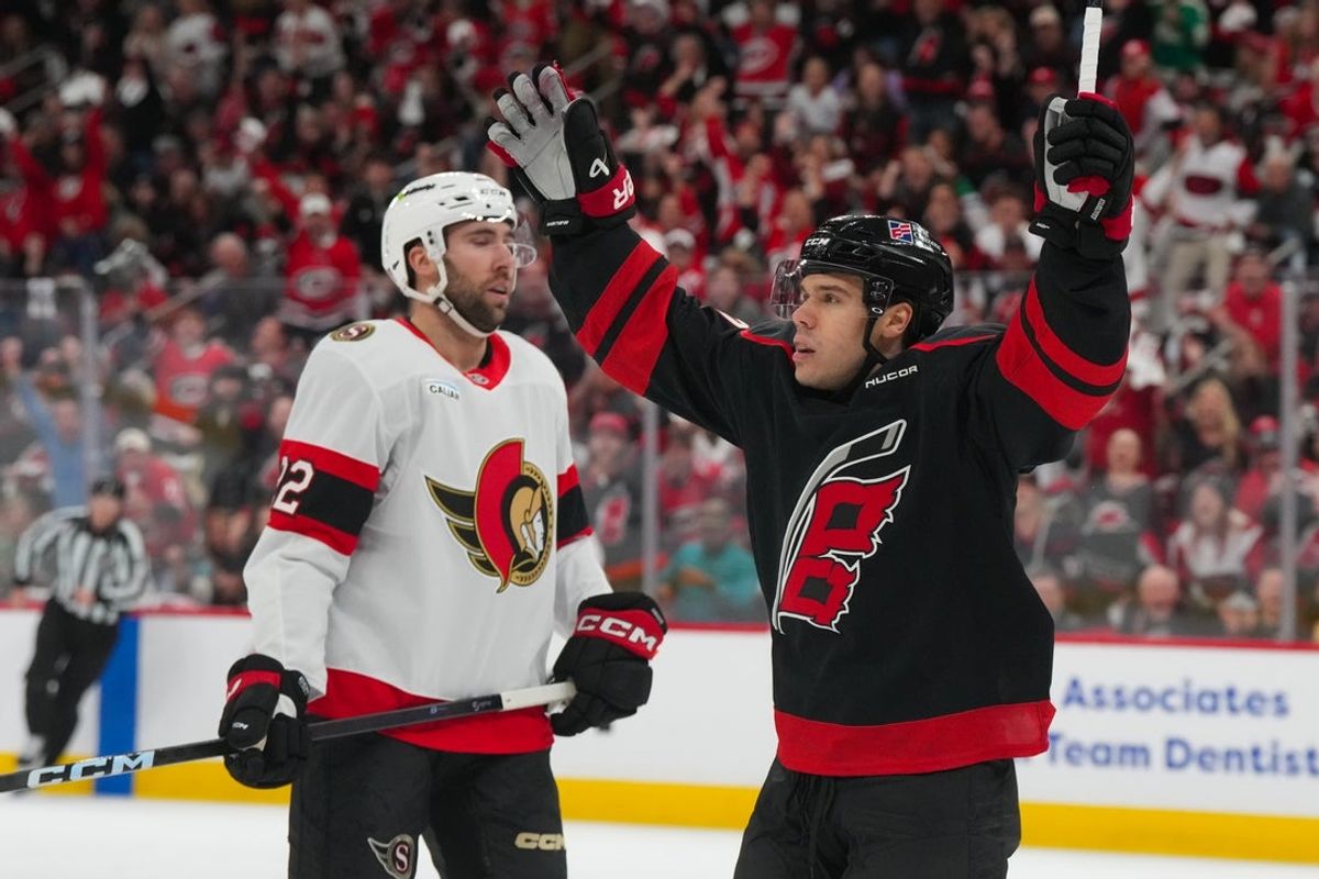 Apr 20, 2026; Raleigh, North Carolina, USA; Carolina Hurricanes center Logan Stankoven (22) celebrates his goal against the Ottawa Senators during the first period in game two of the first round of the 2026 Stanley Cup Playoffs at Lenovo Center. Mandatory Credit: James Guillory-Imagn Images