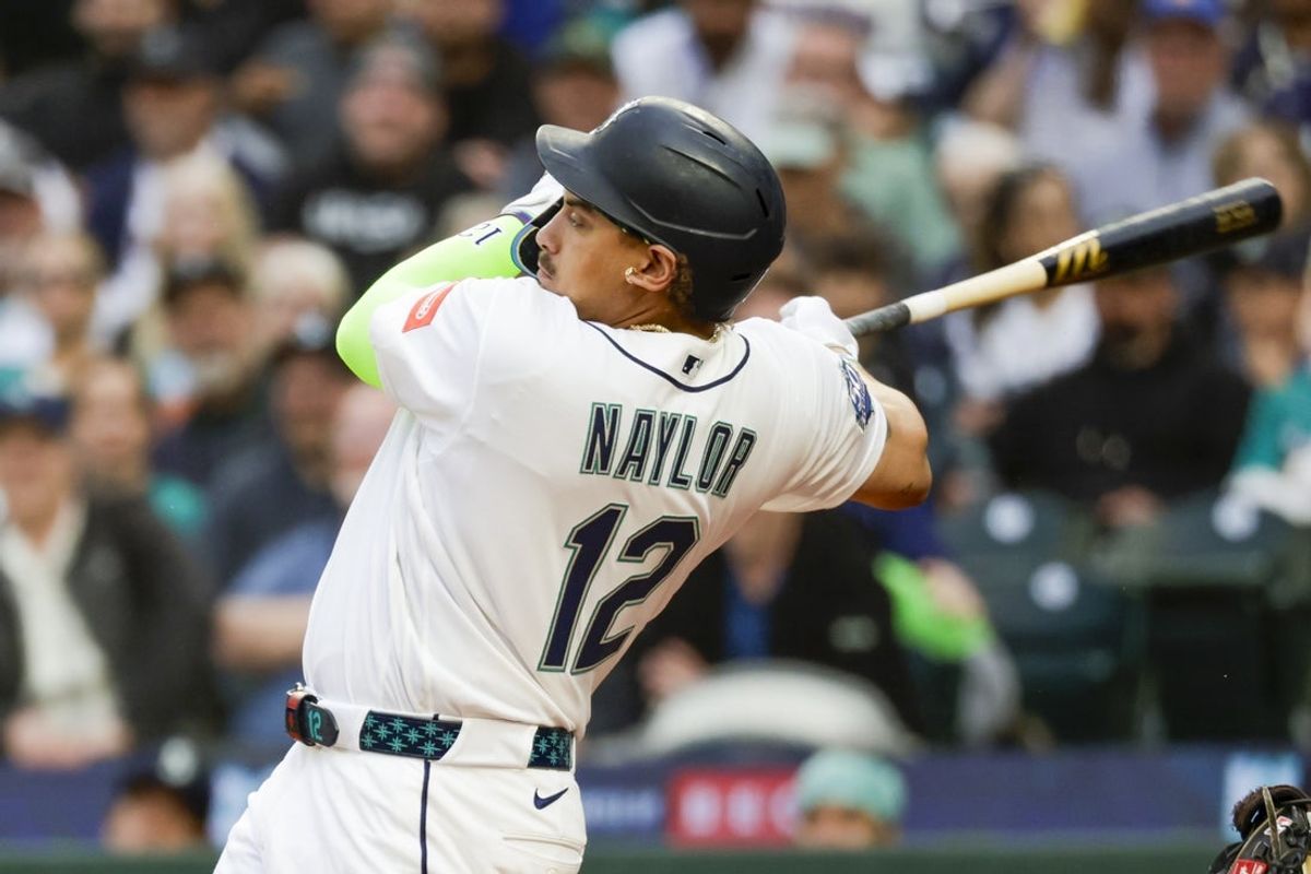 Apr 20, 2026; Seattle, Washington, USA; Seattle Mariners first baseman Josh Naylor (12) hits an RBI-double against the Athletics during the first inning at T-Mobile Park. Mandatory Credit: Joe Nicholson-Imagn Images
