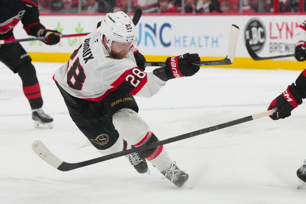 Apr 20, 2026; Raleigh, North Carolina, USA; Ottawa Senators right wing Claude Giroux (28) gets the shot away against the Carolina Hurricanes during the first overtime in game two of the first round of the 2026 Stanley Cup Playoffs at Lenovo Center.