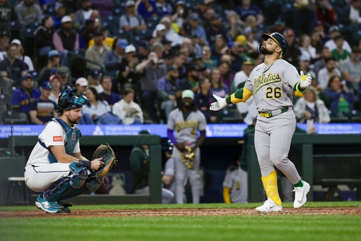 Apr 20, 2026; Seattle, Washington, USA; Athletics designated hitter Carlos Cortes (26) runs the bases after hitting a solo-home run against the Seattle Mariners during the fourth inning at T-Mobile Park. Seattle Mariners catcher Cal Raleigh (29) squats at left. Mandatory Credit: Joe Nicholson-Imagn Images