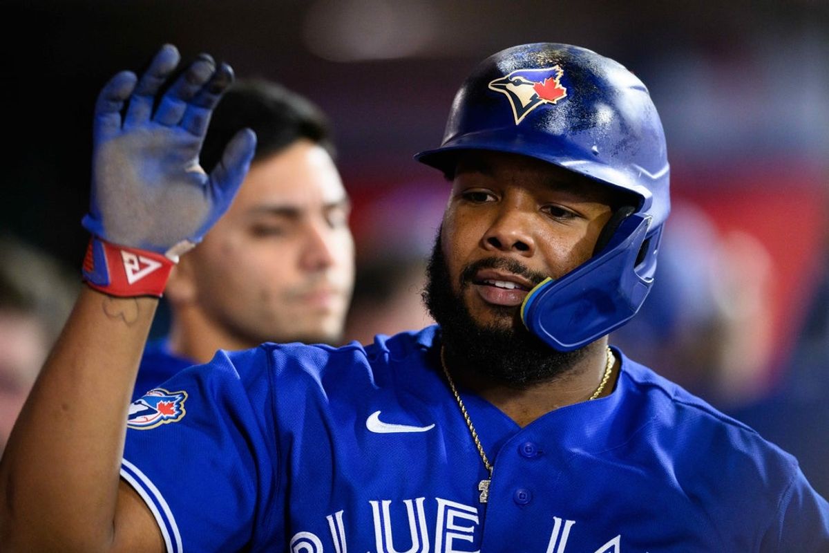 Apr 20, 2026; Anaheim, California, USA; Toronto Blue Jays first baseman Vladimir Guerrero Jr. (27) is greeted by teammates after scoring during the sixth inning against the Los Angeles Angels at Angel Stadium. Mandatory Credit: William Liang-Imagn Images