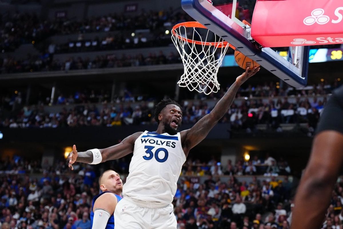 Apr 20, 2026; Denver, Colorado, USA; Minnesota Timberwolves forward Julius Randle (30) finishes off a basket in the first half against the Denver Nuggets during game two of the first round of the 2026 NBA Playoffs at Ball Arena. Mandatory Credit: Ron Chenoy-Imagn Images