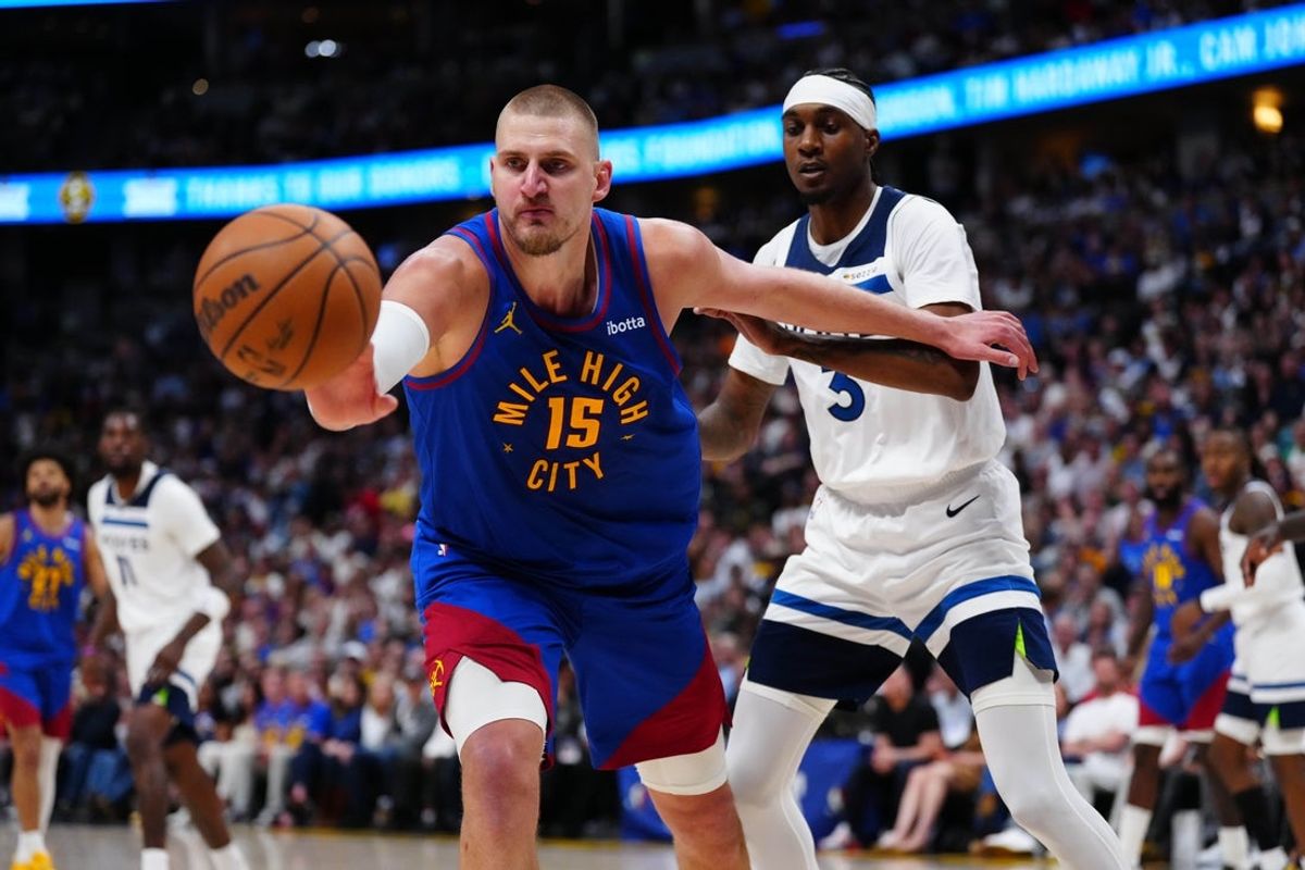 Apr 20, 2026; Denver, Colorado, USA; Minnesota Timberwolves forward Jaden McDaniels (3) defends on Denver Nuggets center Nikola Jokic (15) in the second half during game two of the first round of the 2026 NBA Playoffs at Ball Arena. Mandatory Credit: Ron Chenoy-Imagn Images
