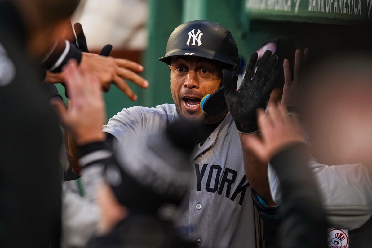 Apr 21, 2026; Boston, Massachusetts, USA; New York Yankees designated hitter Giancarlo Stanton (27) reacts with teammates after hitting a home run against the Boston Red Sox in the second inning at Fenway Park. Mandatory Credit: David Butler II-Imagn Images