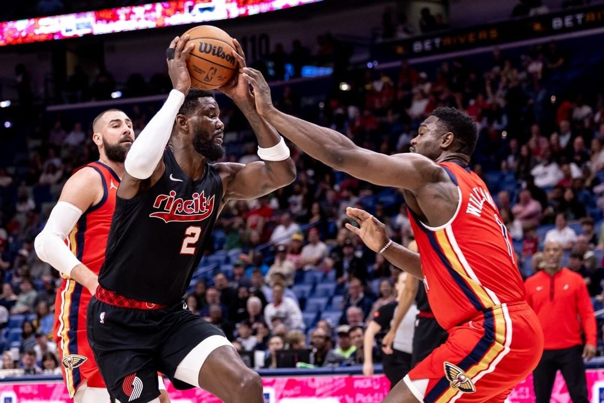 Mar 16, 2024; New Orleans, Louisiana, USA;  Portland Trail Blazers center Deandre Ayton (2) dribbles against New Orleans Pelicans forward Zion Williamson (1) during the first half at Smoothie King Center.