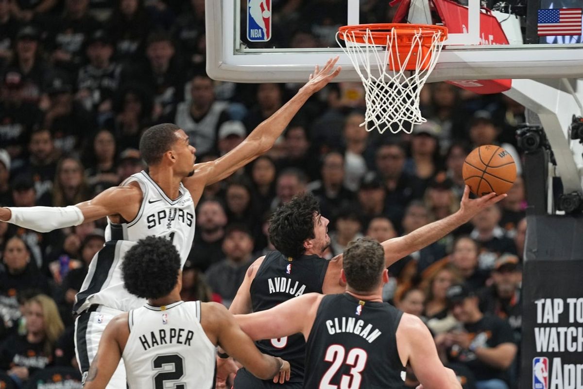 Apr 21, 2026; San Antonio, Texas, USA; Portland Trail Blazers forward Deni Avdija (8) drives to the basket past San Antonio Spurs forward Victor Wembanyama (1) during the first half of game two of the first round of the 2026 NBA Playoffs at Frost Bank Center. Mandatory Credit: Scott Wachter-Imagn Images