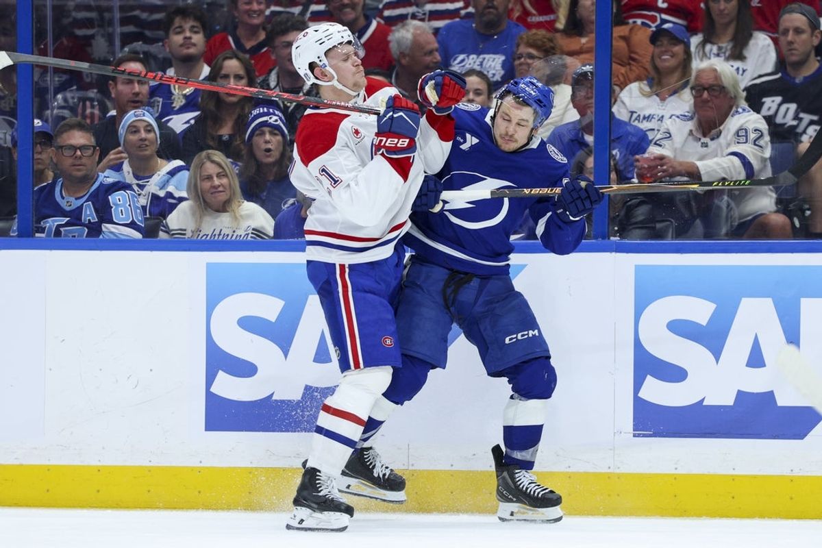Apr 21, 2026; Tampa, Florida, USA; Montreal Canadiens defenseman Kaiden Guhle (21) collides with Tampa Bay Lightning center Yanni Gourde (37) in the second period during game two of the first round of the 2026 Stanley Cup Playoffs at Benchmark International Arena. Mandatory Credit: Nathan Ray Seebeck-Imagn Images