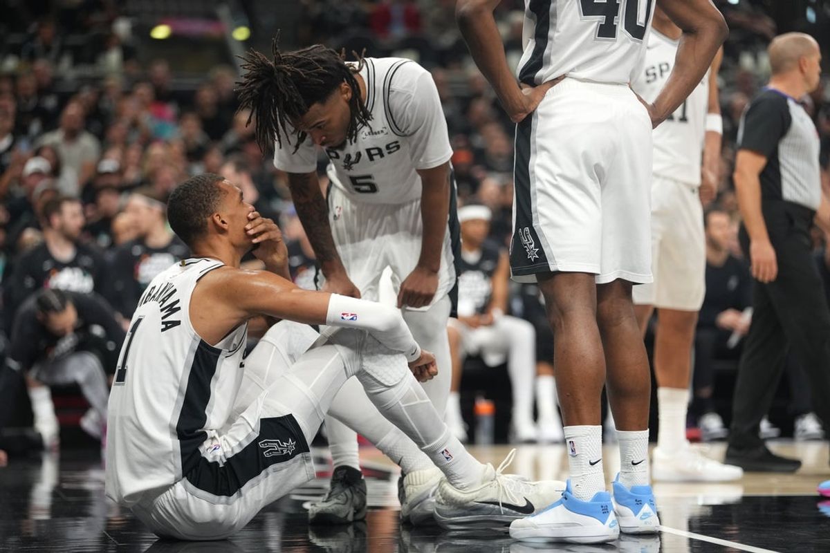 Apr 21, 2026; San Antonio, Texas, USA; San Antonio Spurs forward Victor Wembanyama (1) talks with guard Stephon Castle (5) after falling to the ground during the first half of game two of the first round of the 2026 NBA Playoffs against the Portland Trail Blazers at Frost Bank Center. Mandatory Credit: Scott Wachter-Imagn Images