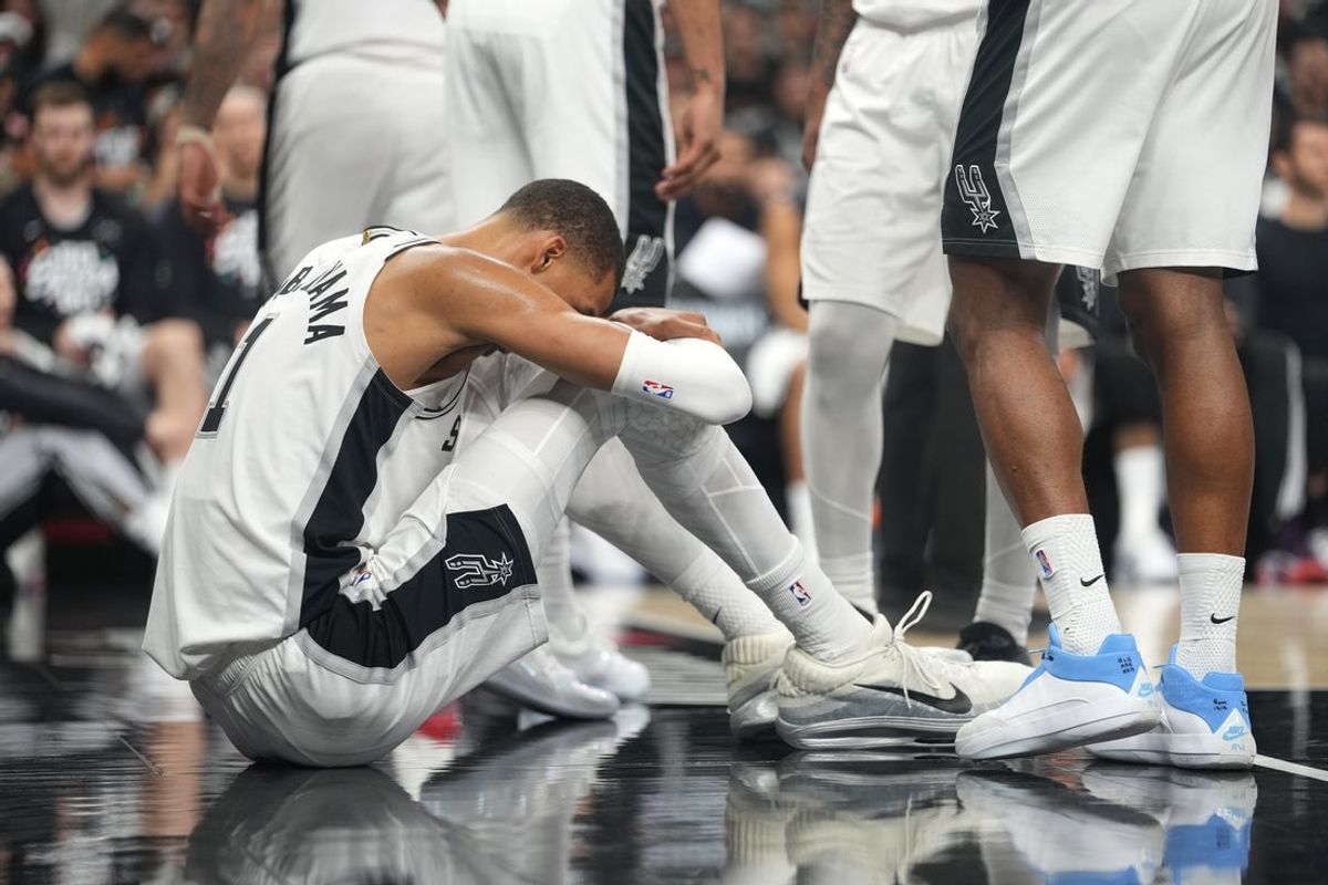 Apr 21, 2026; San Antonio, Texas, USA; San Antonio Spurs forward Victor Wembanyama (1) reacts after falling to the ground during the first half of game two of the first round of the 2026 NBA Playoffs against the Portland Trail Blazers at Frost Bank Center. Mandatory Credit: Scott Wachter-Imagn Images