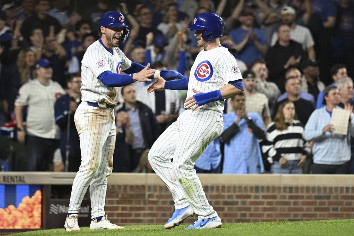 Apr 21, 2026; Chicago, Illinois, USA;  Chicago Cubs second baseman Nico Hoerner (2) high fives left fielder Ian Happ (8), right, after scoring during the sixth inning against the Philadelphia Phillies at Wrigley Field. Mandatory Credit: Matt Marton-Imagn Images