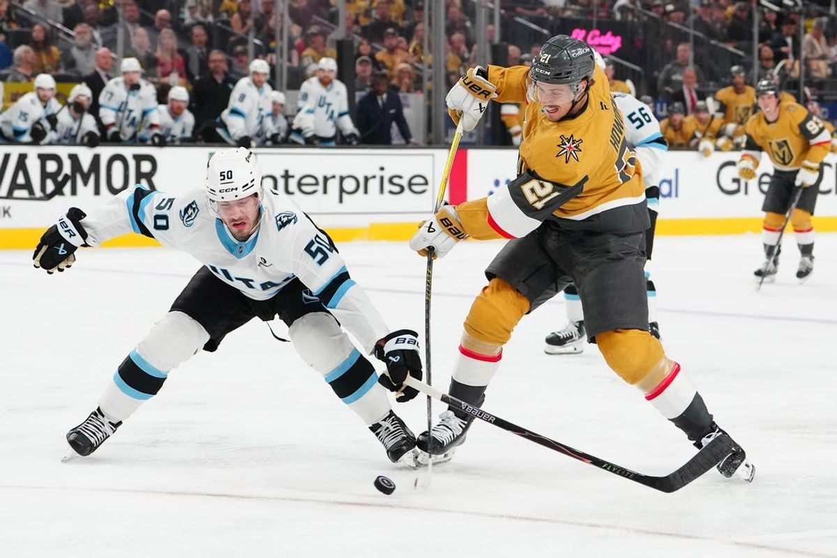 Apr 21, 2026; Las Vegas, Nevada, USA; Utah Mammoth defenseman Sean Durzi (50) attempts to deflect a shot attempt by Vegas Golden Knights center Brett Howden (21) during the first period of game two of the first round of the 2026 Stanley Cup Playoffs at T-Mobile Arena. Mandatory Credit: Stephen R. Sylvanie-Imagn Images
