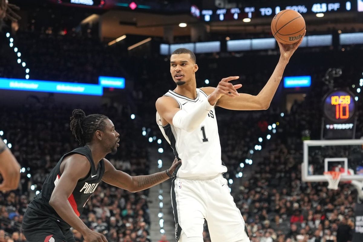 Apr 21, 2026; San Antonio, Texas, USA; San Antonio Spurs forward Victor Wembanyama (1) looks to pass against Portland Trail Blazers guard Jrue Holiday (5) during the first half of game two of the first round of the 2026 NBA Playoffs at Frost Bank Center. Mandatory Credit: Scott Wachter-Imagn Images