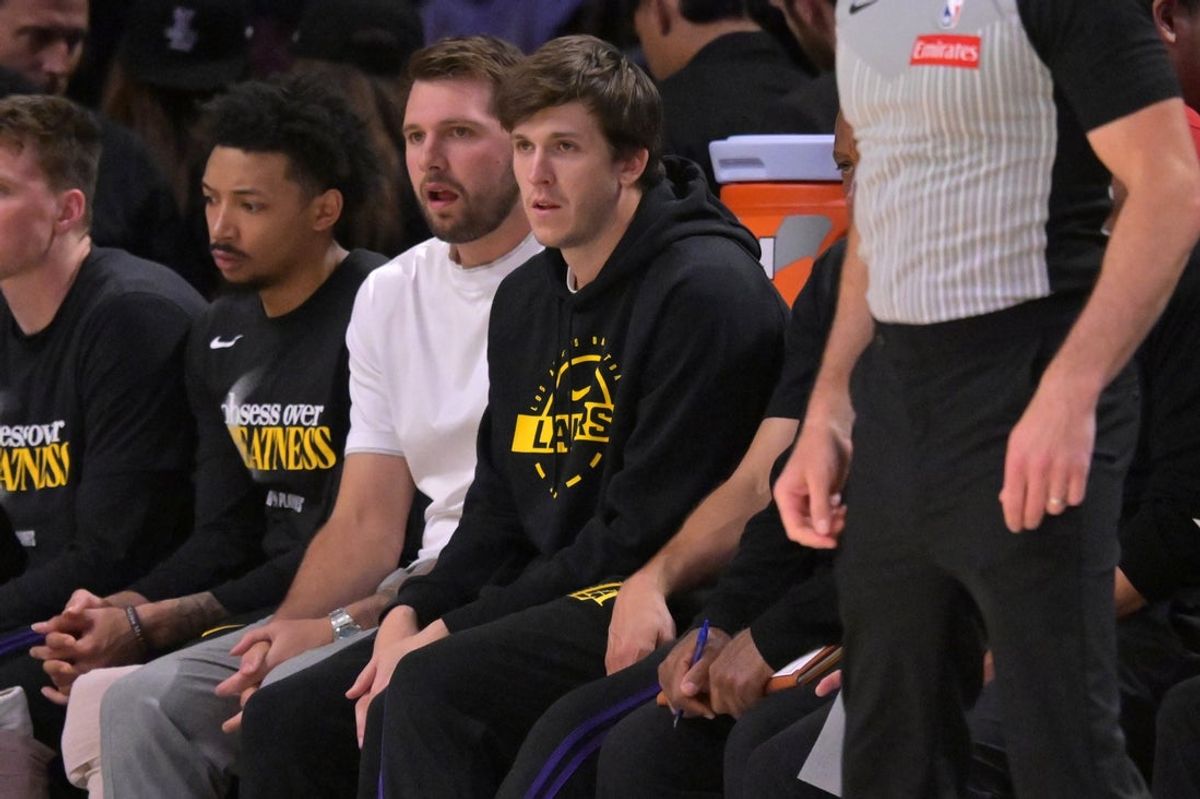 Apr 21, 2026; Los Angeles, California, USA; Los Angeles Lakers guard Luka Doncic (77) and guard Austin Reaves (15) look on from the bench in the first half of game two of the first round of the 2026 NBA Playoffs against the Houston Rockets at Crypto.com Arena. Mandatory Credit: Jayne Kamin-Oncea-Imagn Images