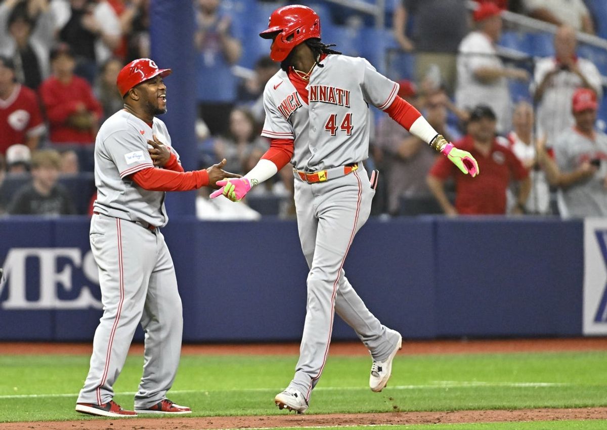 Apr 21, 2026; St. Petersburg, Florida, USA; Cincinnati Reds infielder Elly De La Cruz (44) celebrates a home run with coach Willie Harris (99) during the ninth inning against Tampa Bay Rays at Tropicana Field. Mandatory Credit: Pablo Robles-Imagn Images