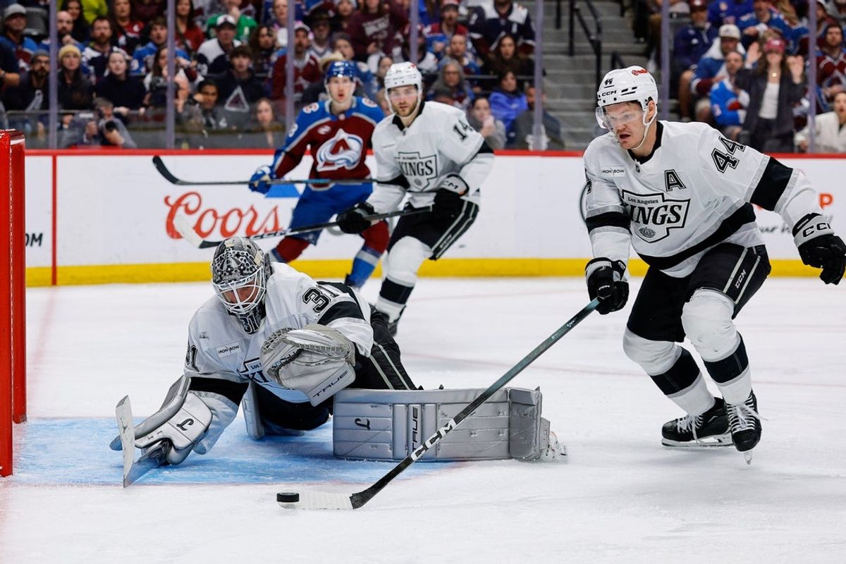 Apr 21, 2026; Denver, Colorado, USA; Los Angeles Kings defenseman Mikey Anderson (44) controls the puck ahead of goaltender Anton Forsberg (31) in overtime against the Colorado Avalanche in game two of the first round of the 2026 Stanley Cup Playoffs at Ball Arena. Mandatory Credit: Isaiah J. Downing-Imagn Images