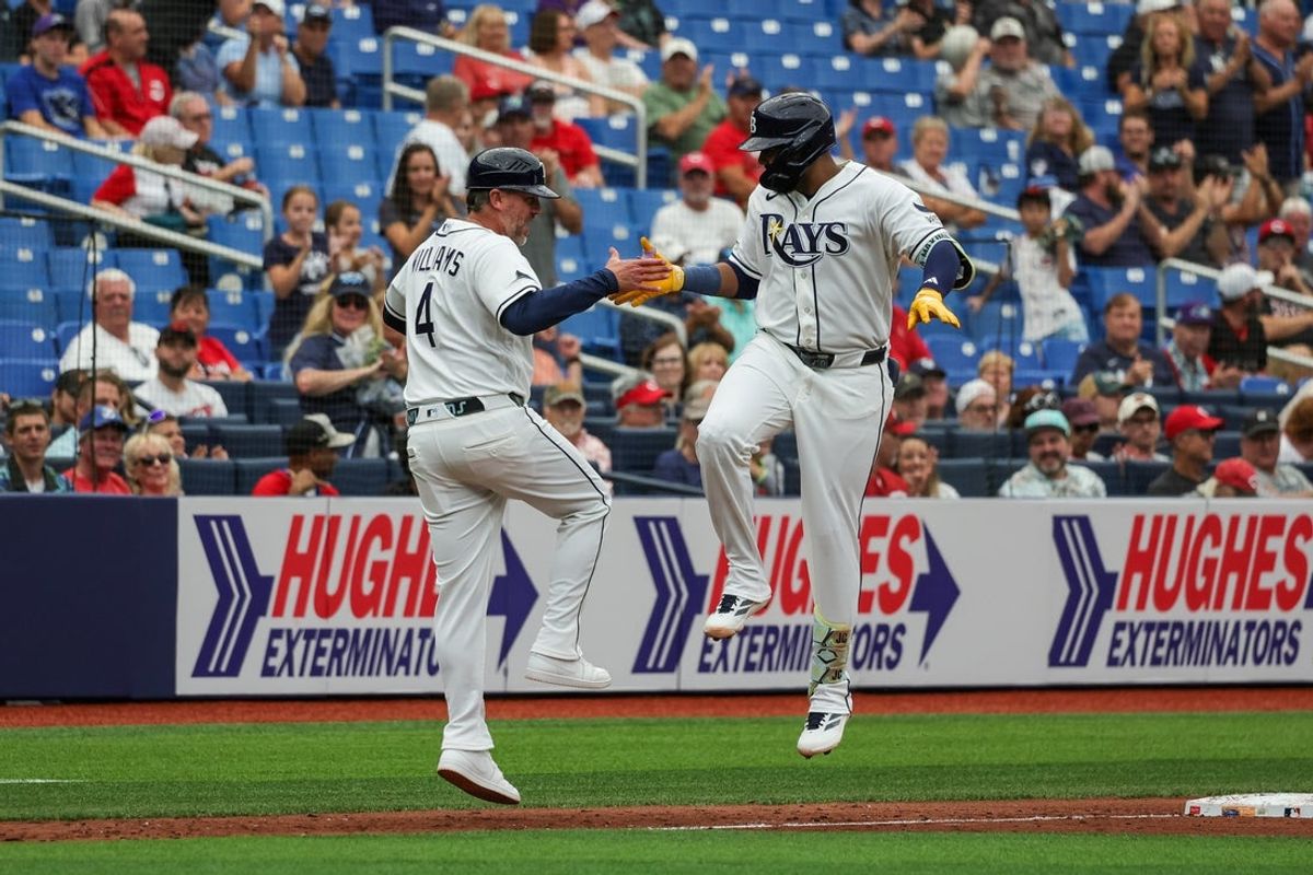 Apr 22, 2026; St. Petersburg, Florida, USA; Tampa Bay Rays third baseman Junior Caminero (13) celebrates with Tampa Bay Rays third base coach Brady Williams (4) after hitting a home run during the third inning against the Cincinnati Reds at Tropicana Field. Mandatory Credit: Mike Watters-Imagn Images