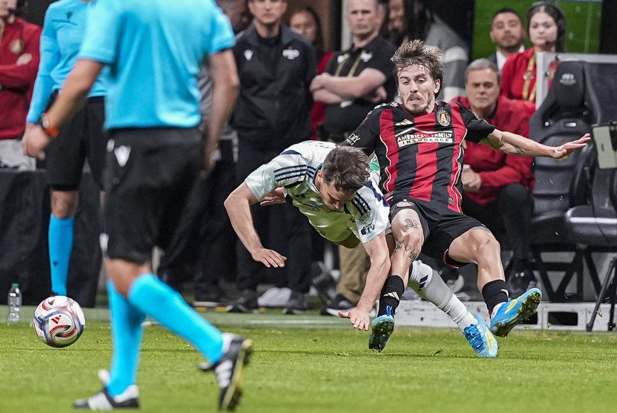 Apr 22, 2026; Atlanta, Georgia, USA; New England Revolution defender Will Sands (23) and Atlanta United midfielder Saba Lobjanidze (11) collide while fighting for the ball during the first half at Mercedes-Benz Stadium. Mandatory Credit: Dale Zanine-Imagn Images