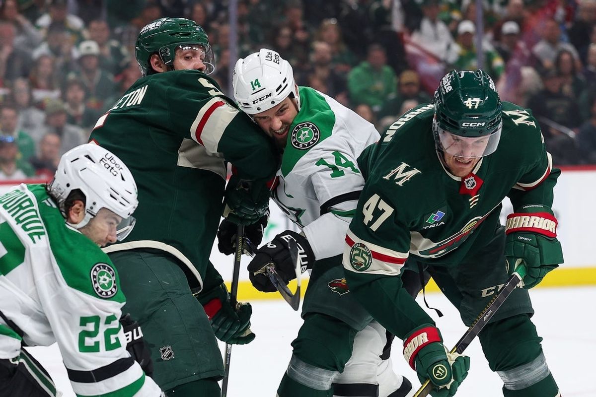 Apr 22, 2026; Saint Paul, Minnesota, USA; Minnesota Wild defenseman Jake Middleton (5), center Michael McCarron (47) and Dallas Stars left wing Jamie Benn (14) complete for the puck during the first period in game three of the first round of the 2026 Stanley Cup Playoffs at Grand Casino Arena. Mandatory Credit: Matt Krohn-Imagn Images