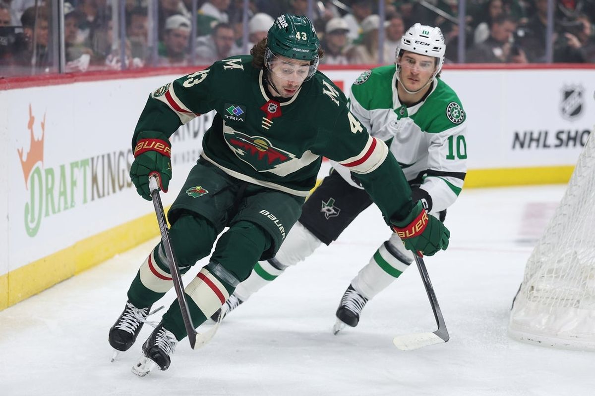 Apr 22, 2026; Saint Paul, Minnesota, USA; Minnesota Wild defenseman Quinn Hughes (43) and Dallas Stars center Oskar Bäck (10) compete for the puck during the first period in game three of the first round of the 2026 Stanley Cup Playoffs at Grand Casino Arena. Mandatory Credit: Matt Krohn-Imagn Images