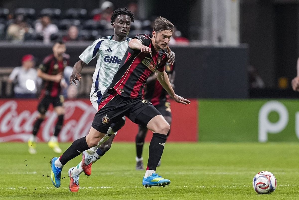 Apr 22, 2026; Atlanta, Georgia, USA; Atlanta United midfielder Alexey Miranchuk (59) is grabbed from behind by New England Revolution defender Mamadou Fofana (2) during the second half at Mercedes-Benz Stadium. Mandatory Credit: Dale Zanine-Imagn Images