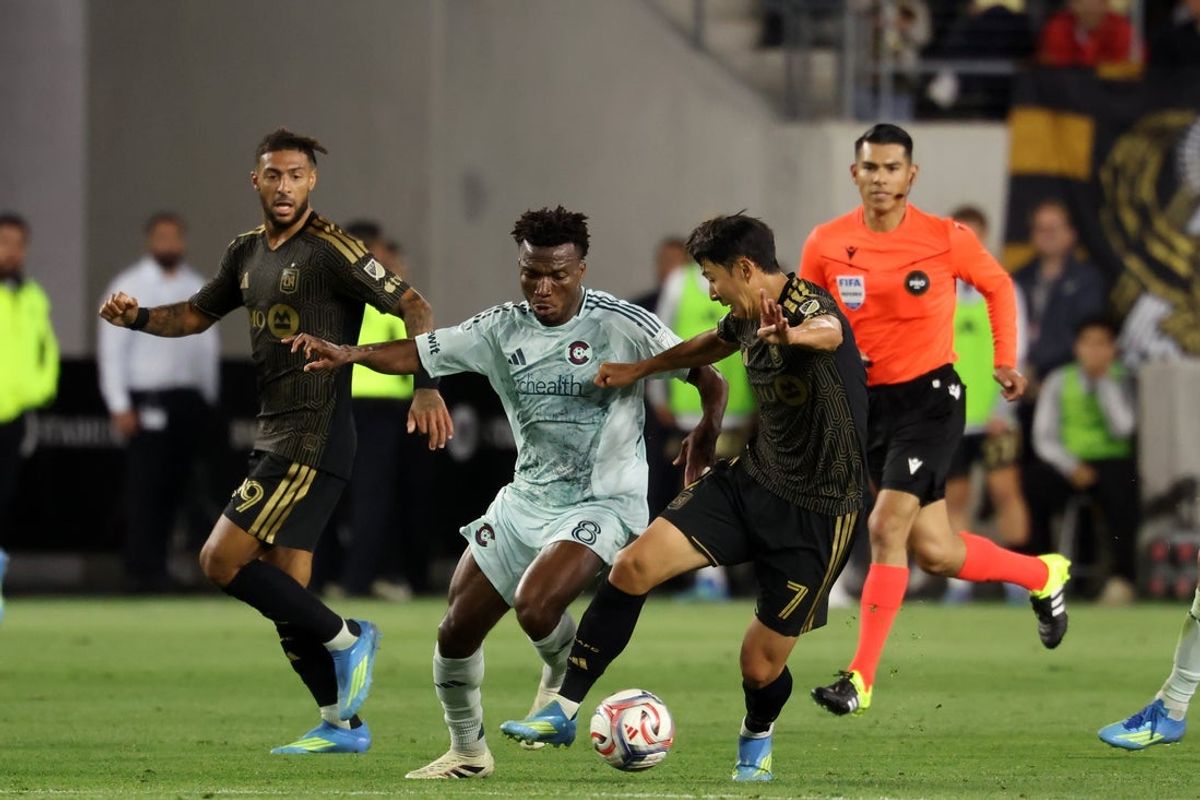 Apr 22, 2026; Los Angeles, California, USA;  LAFC forward Son Heung-Min (7) fight for the ball against Colorado Rapids midfielder Hamzat Ojediran (8) during the first half at BMO Stadium. Mandatory Credit: Kiyoshi Mio-Imagn Images