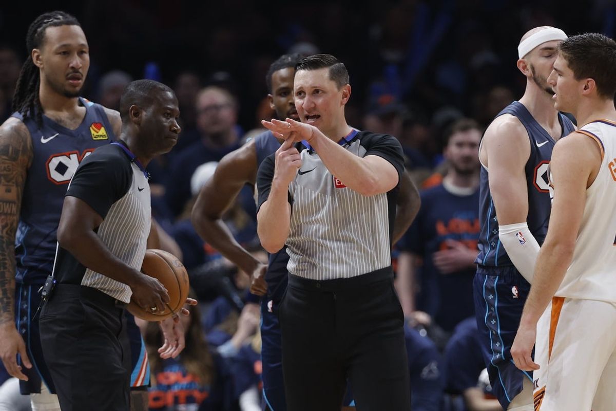 Apr 22, 2026; Oklahoma City, Oklahoma, USA; NBA referee JB DeRosa calls a technical on Phoenix Suns guard Devin Booker (1) in the second half during game two of the first round of the 2026 NBA Playoffs against the Oklahoma City Thunder at Paycom Center. Mandatory Credit: Alonzo Adams-Imagn Images