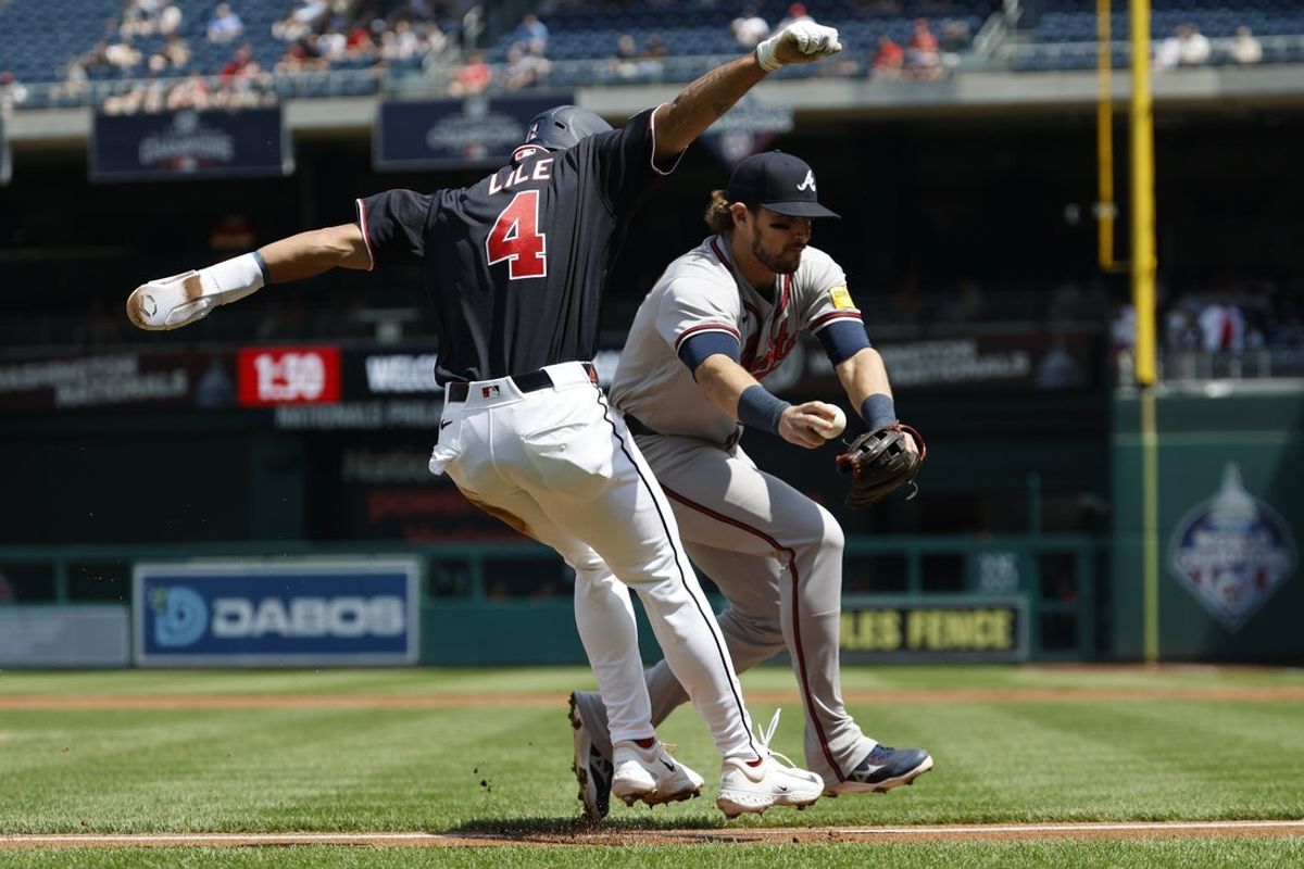 Apr 23, 2026; Washington, District of Columbia, USA; Washington Nationals right fielder Daylen Lile (4) is called out during a rundown off of third base by Atlanta Braves third baseman Austin Riley (27) during the second inning at Nationals Park. Mandatory Credit: Geoff Burke-Imagn Images