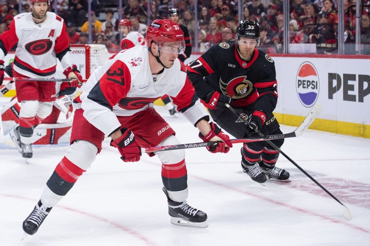 Apr 23, 2026; Ottawa, Ontario, CAN; Carolina Hurricanes right wing Andrei Svechnikov (37) and Ottawa Senators left wing Warren Foegele (37) chase the puck in the first period of game three of the first round of the 2026 Stanley Cup Playoffs at the Canadian Tire Centre. Mandatory Credit: Marc DesRosiers-Imagn
